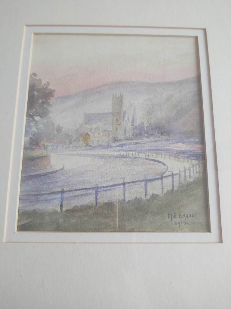 Framed Watercolour? of a river with buildings in the distance.  Signed M.E.Edgar and dated 1915