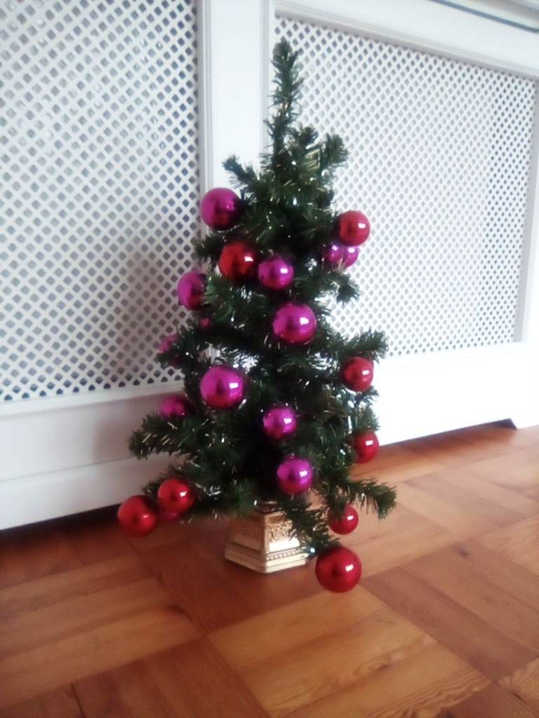John Lewis small artificial Christmas tree, with bauble and other decorations.