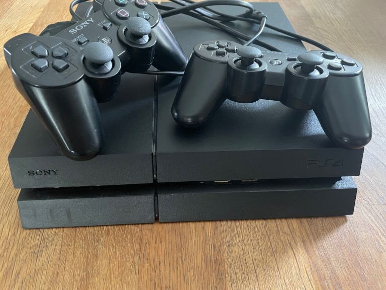 PlayStation 4 console with 2 controllers