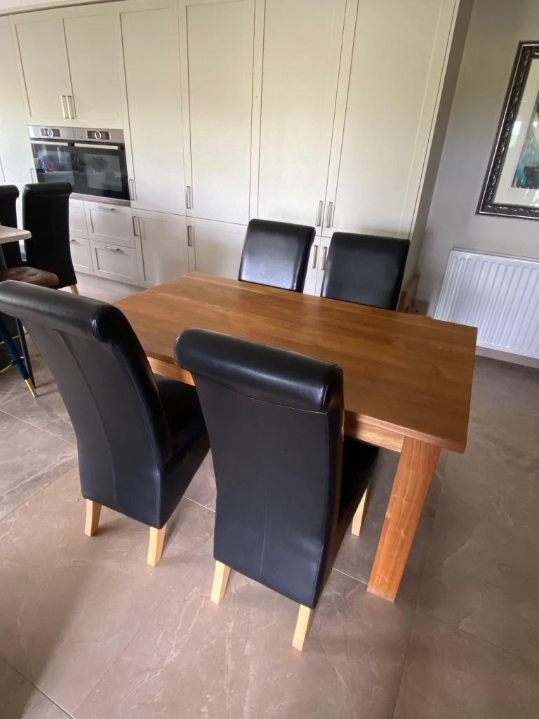 Solid oak dining table and 4 black Italian leather chairs