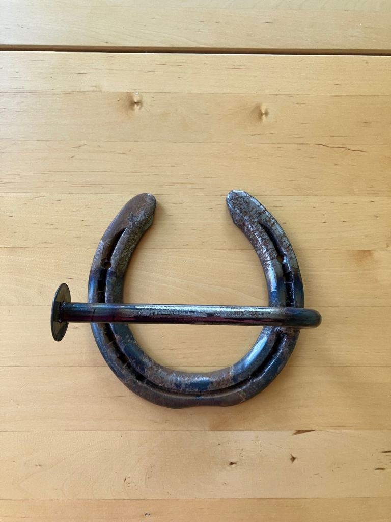 Horse shoe toilet paper holder