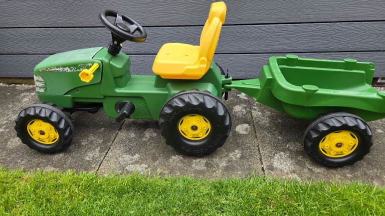 John Deere ride on pedal tractor and trailer with coupling for kids. Fair condition.