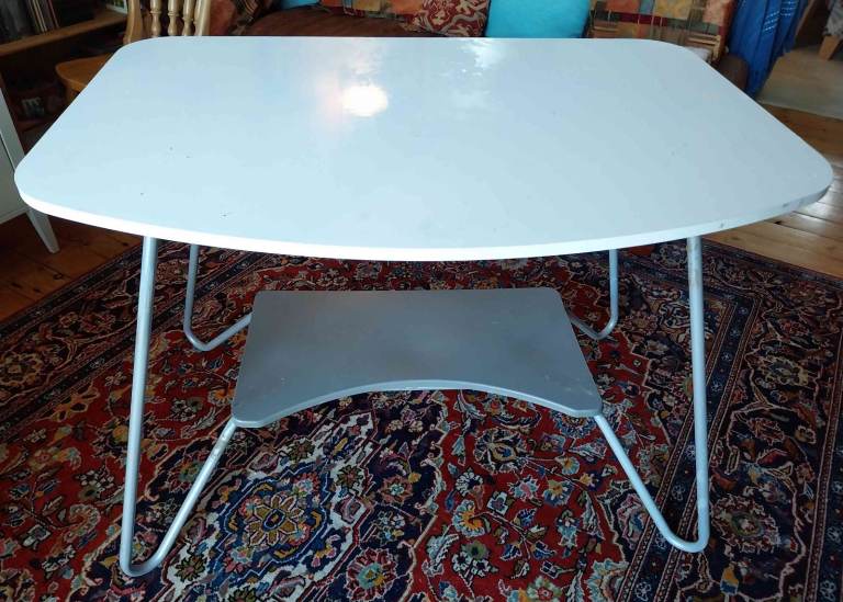 Spacious, light and easily-stored table-cum-desk with wooden top and auxiliary shelf below