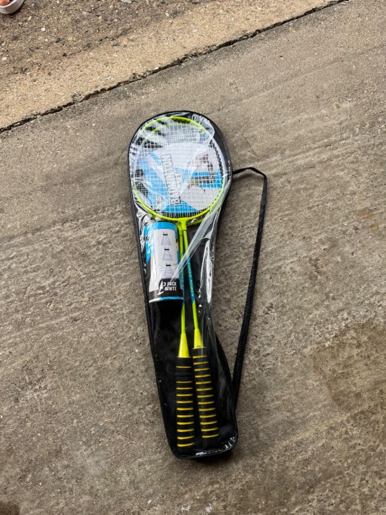 2 badminton rackets with shuttlecocks