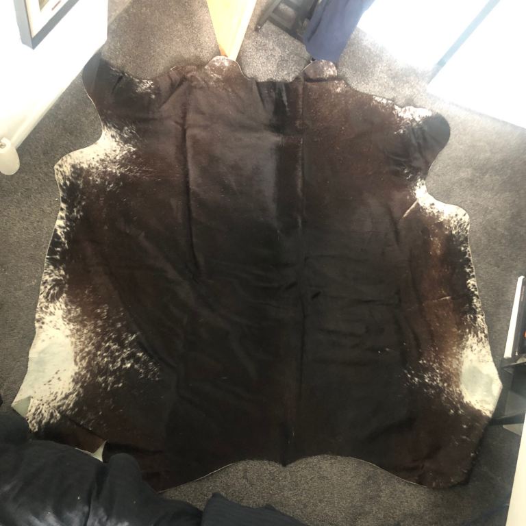 Very large cow hide rug dark browns and white