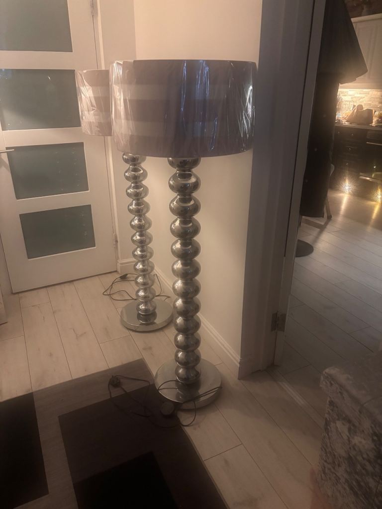 Large silver standard floor lamps with pink and silver shades