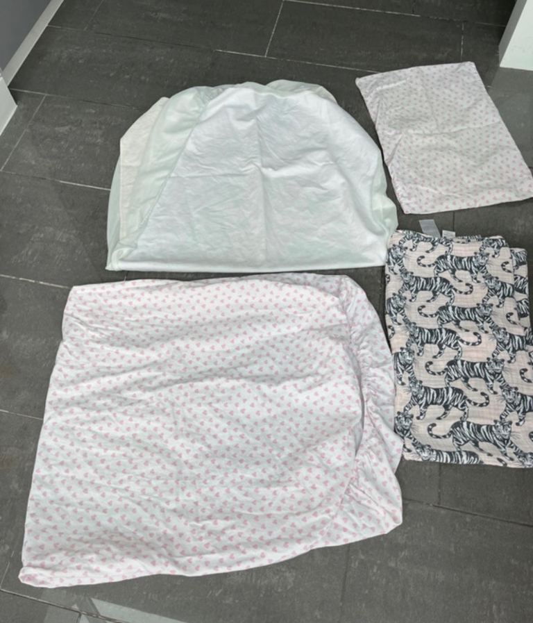 Cot bedding fitted mattress protector, fitted sheet and pillow cover and a muslin sheet