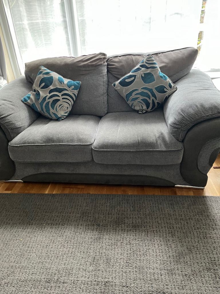 Comfortable Grey Two-Seater Sofa with Cushions – Good Condition
