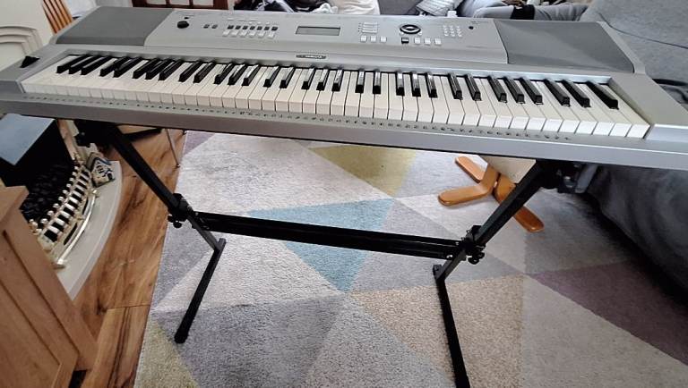 Yamaha DGX-230 Portable Grand Piano Electronic Keyboard is a sleek silver 