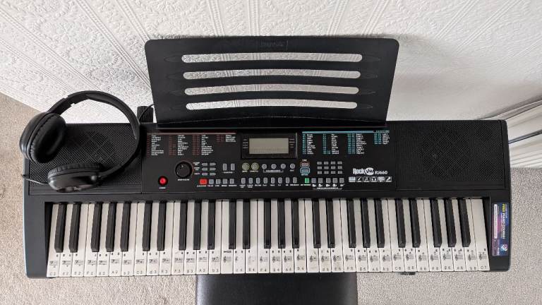 RockJam RJ660 electronic keyboard piano, including stand, adjustable stool, music rest, headphones.