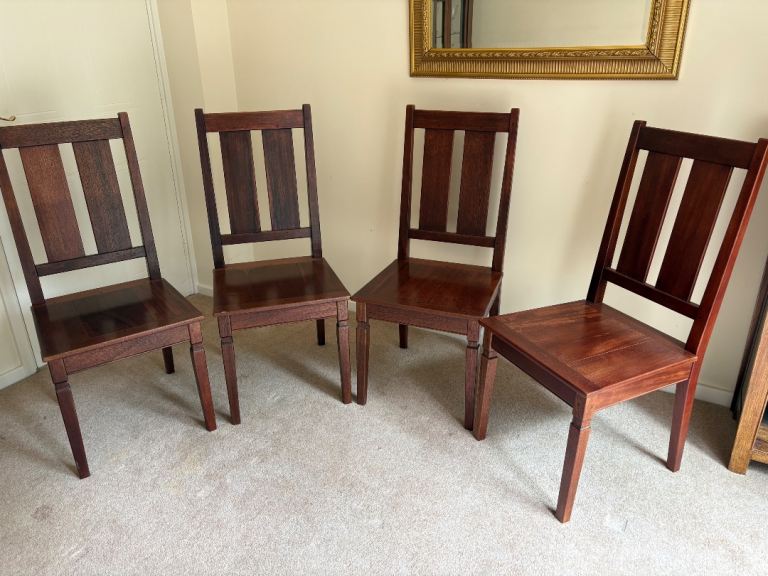 Four hardwood dining chairs 