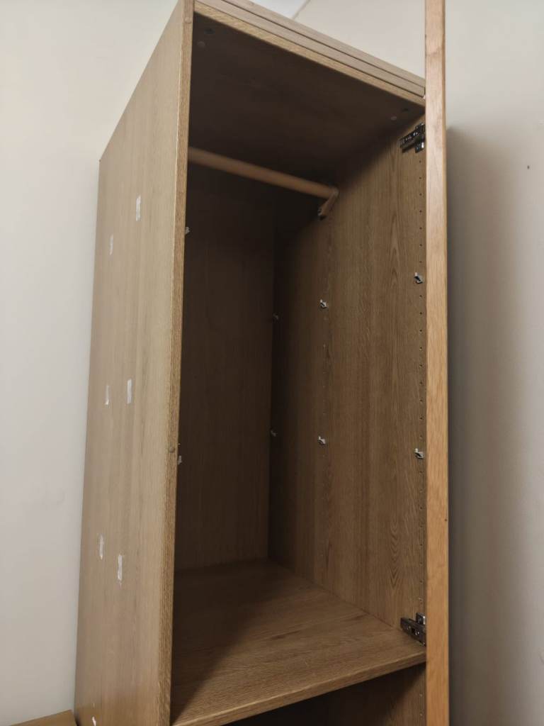 A matching wooden wardrobe and chest of drawers set