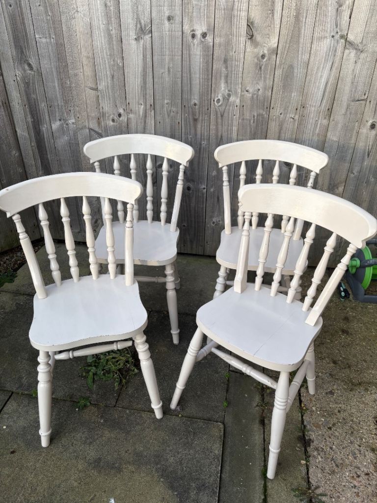 4 farmhouse-style spindle back chairs.