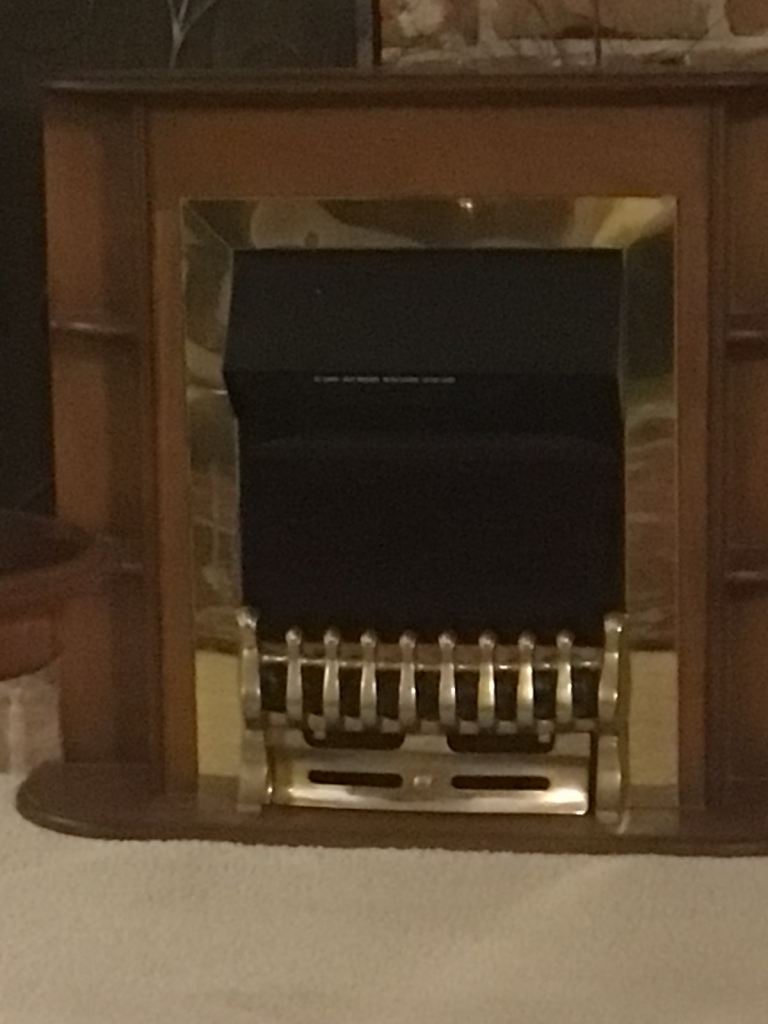 Coal effect electric fire with wood surround