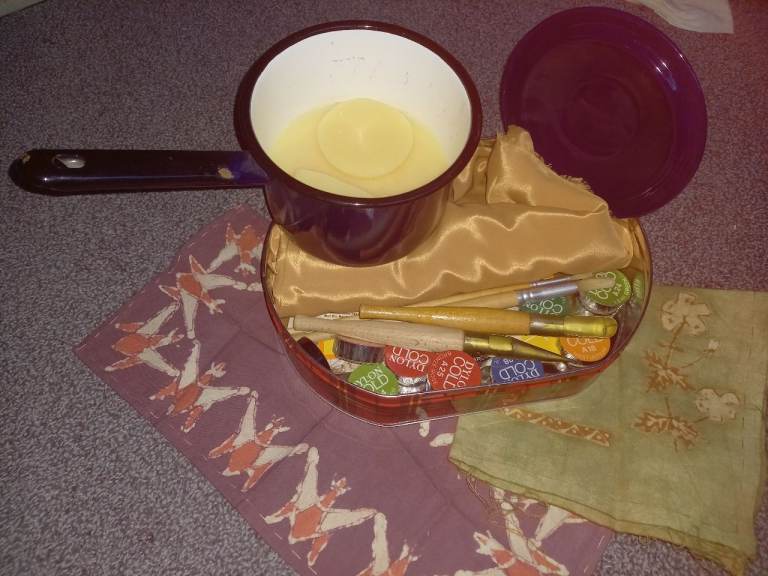 Batik tools, wax in melting pan, dyes and fabric