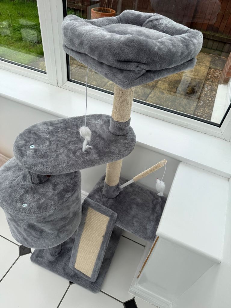 Grey multi-level cat tree with scratching posts and bed
