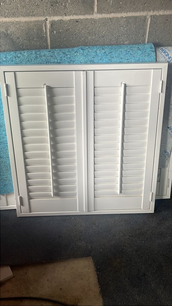 Hillary’s white wooden window shutters 