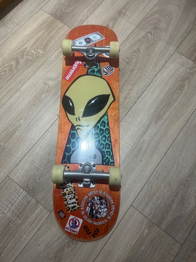 8.25 alien workshop skateboard, mini logo wheels,bullet trucks and a bunch of random stickers