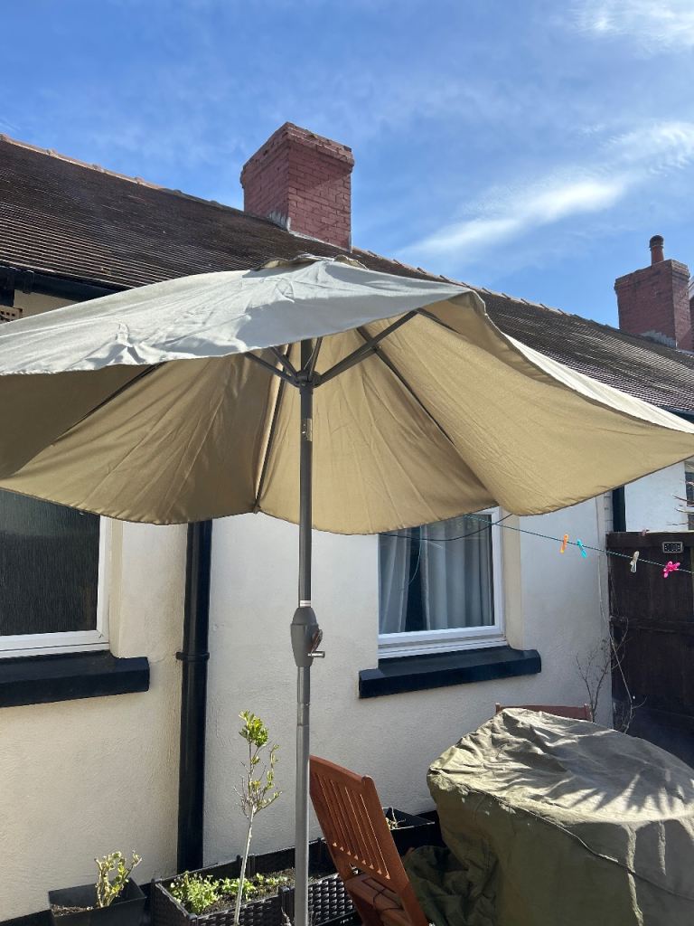 Grey parasol with metal stand