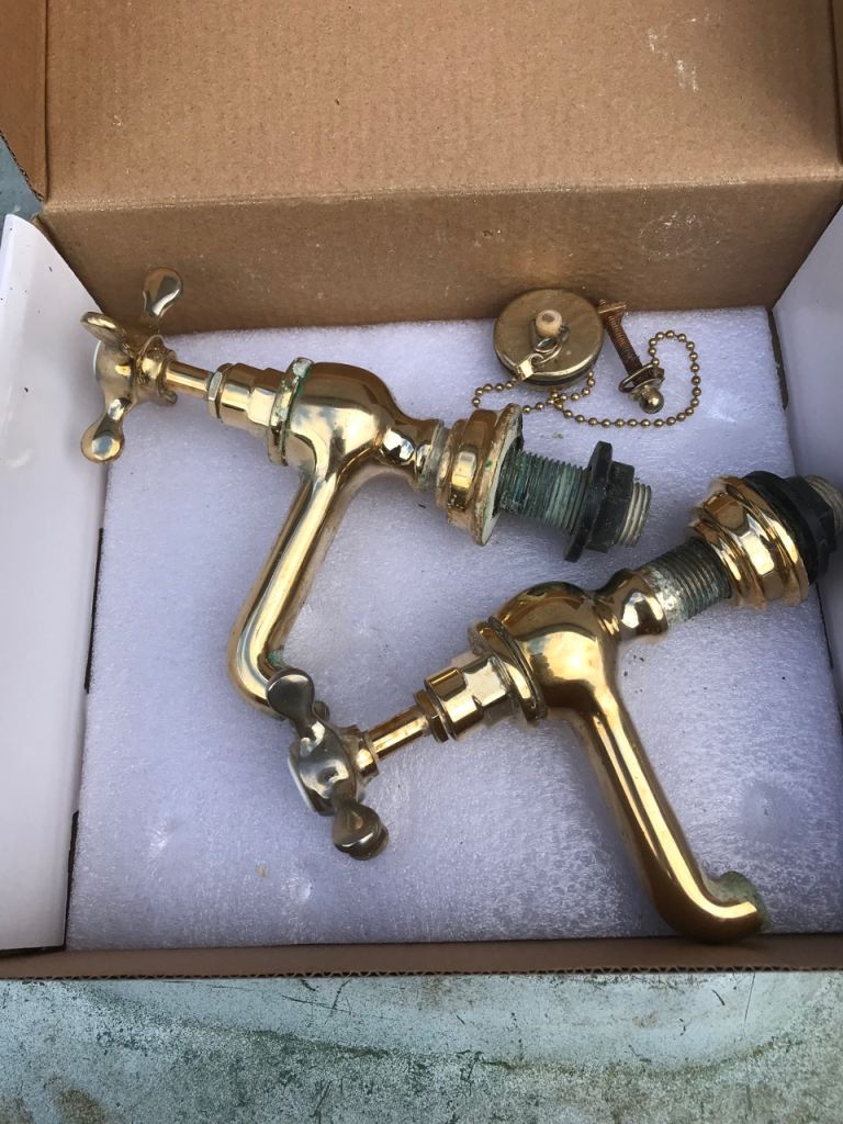 Pair of gold sink taps 