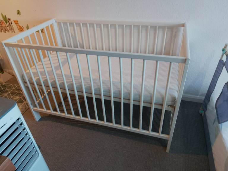 Baby cot and mattress and a ball pit 