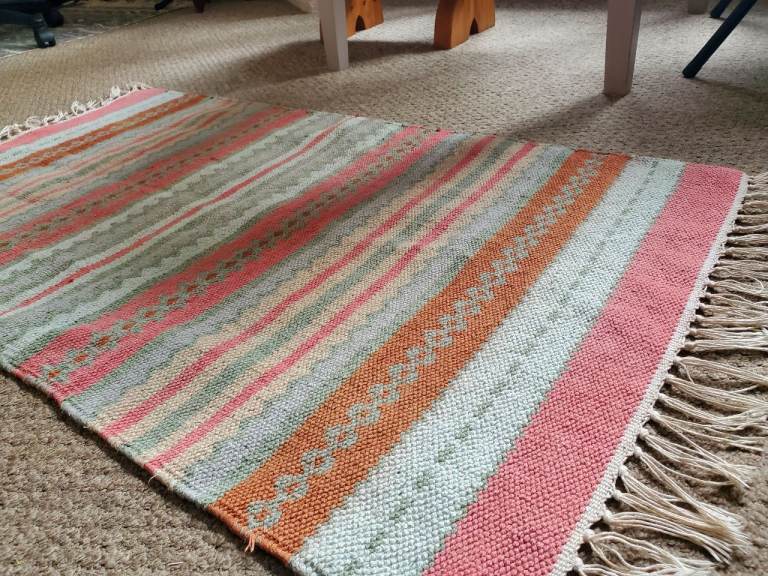 Rug with pink / blue / brown pattern