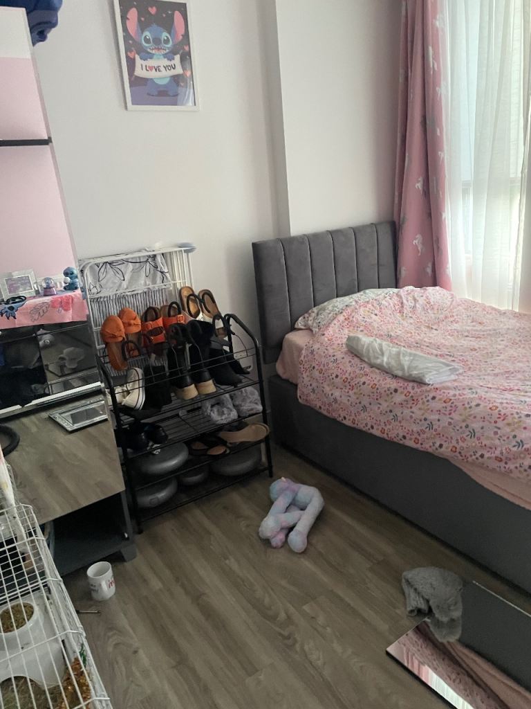 Single grey bed with mattress and bedding 