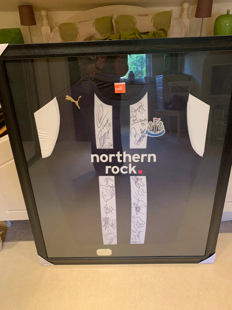 Newcastle United  framed and signed football shirt from all players in 2011 team. 
