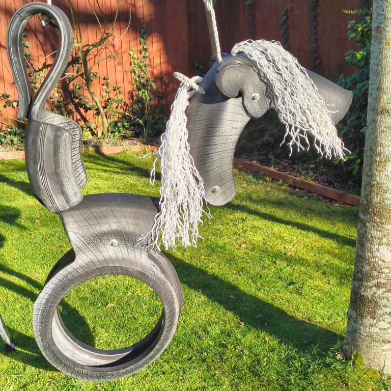 Garden swing. Horse shape made from aircraft tyre.
