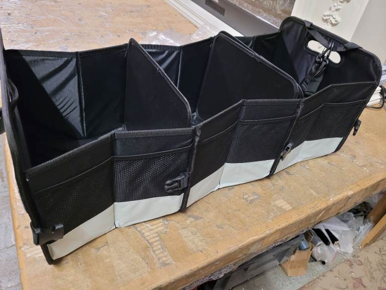 A new still packed Folding car book organizer it has three compartments .