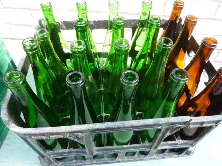 Mixed Green and Brown Glass Bottles in Crate – Good Condition
