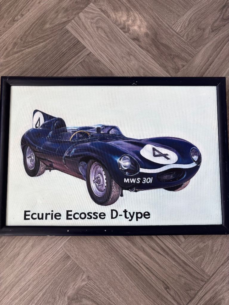 framed artwork of the 1956 Le Mans-winning Jaguar D-Type racing car