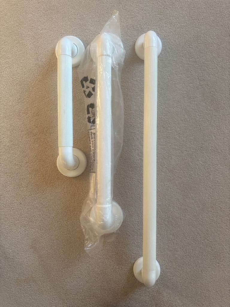 Three white plastic grab rails