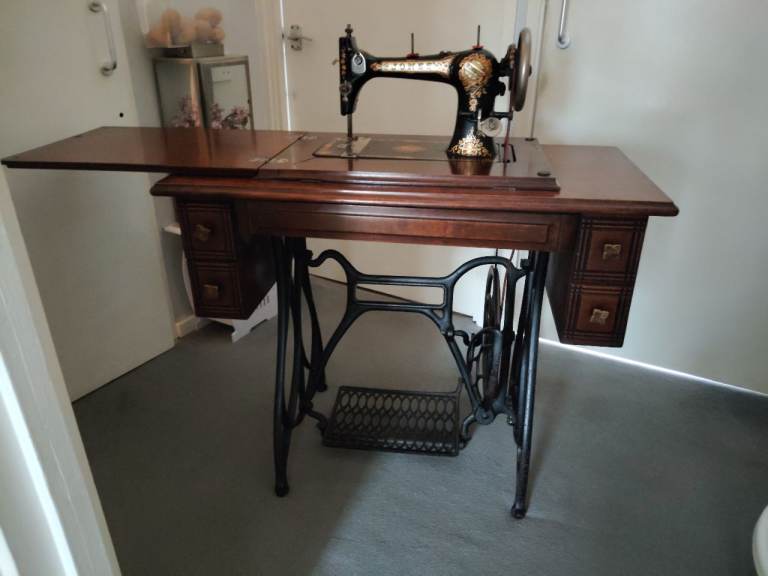 Vintage Sewing Machine with Wooden Cabinet and Treadle Base