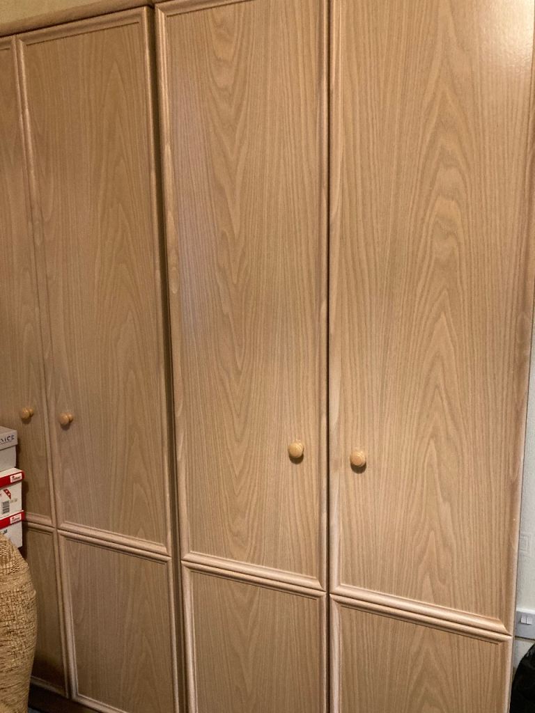 Two double wardrobes and an additional unit with drawers and top storage 