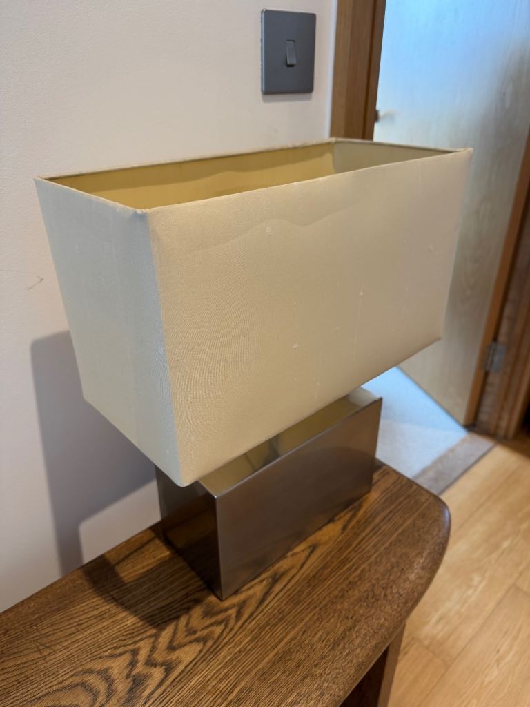 Touch-base table lamp, silver rectangular metal base, fabric shade — two brightness settings