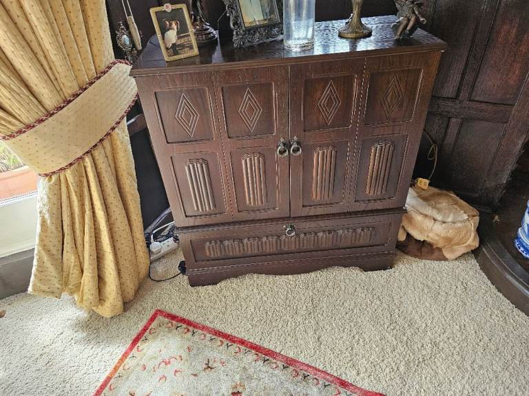 Dark wood TV cabinet with folding doors
