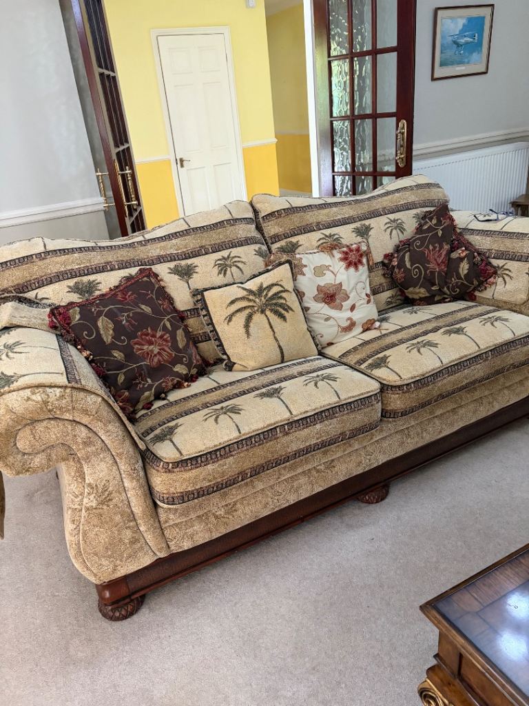 Large double seat sofa palm tree design dark wood detailing. 