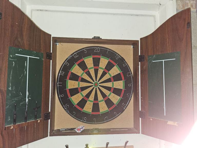 Dart board and cabinet