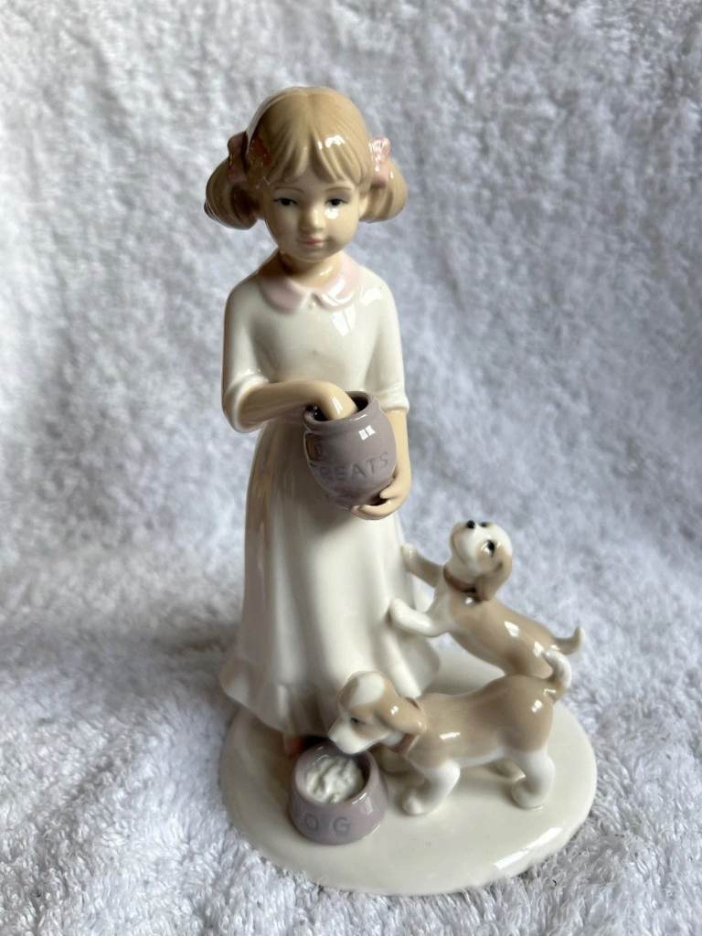Girl feeding her 2 dogs porcelain figurine from The Leonardo collection