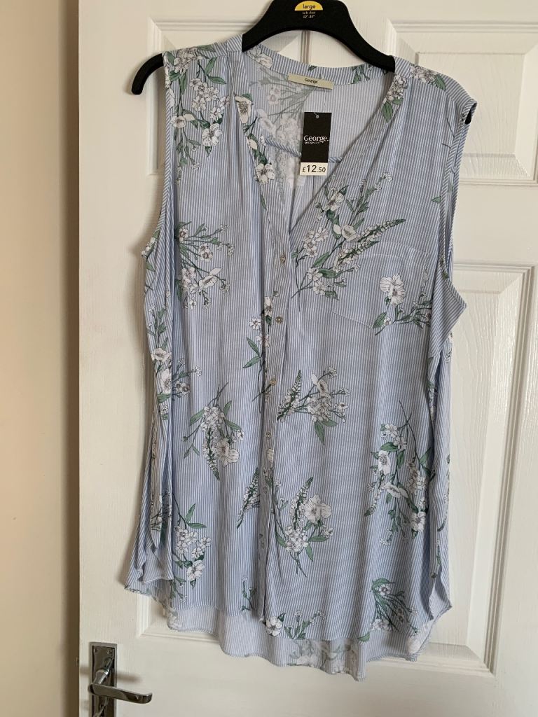 Sleeveless blouse in pale blue and white stripe with v neck with tiny buttons.