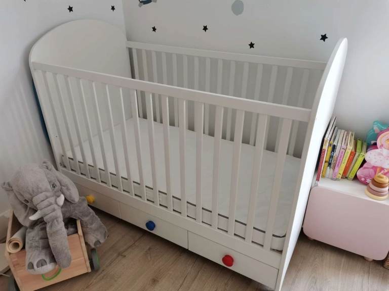 White IKEA GONATT cot bed with storage, with IKEA NATTAPA White Bed Guard Rail and mattress.
