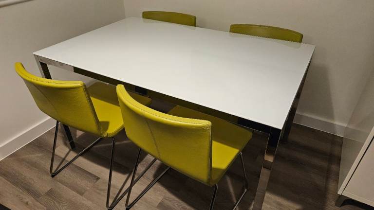 image for Ikea glass topped dining table with four green leather chairs