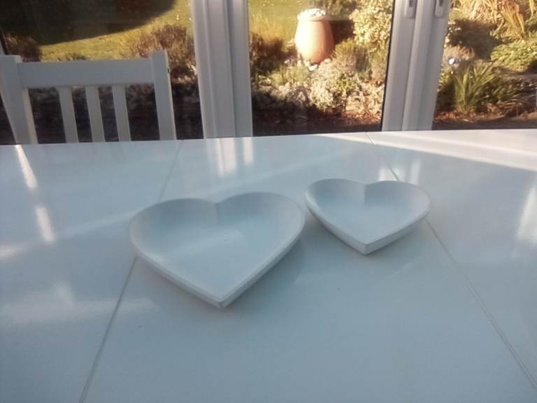 Two heart shaped hand-painted trinket dishes. 