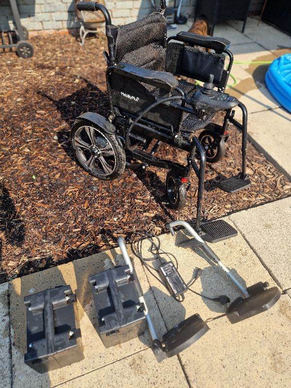 Electric Wheelchair with Charger and Spare Batteries – Good Condition
