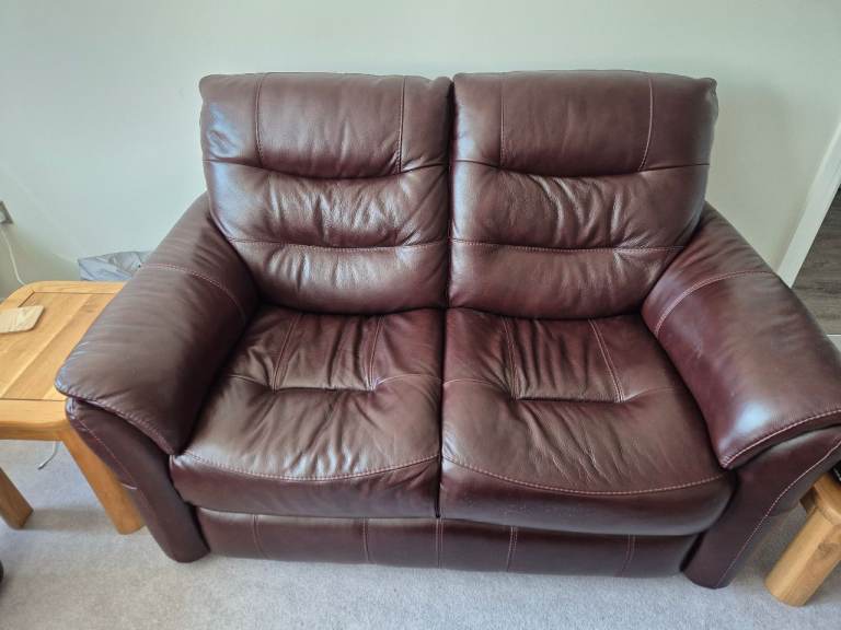 Burgundy leather sofas and stool