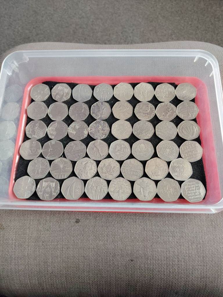 A COLLECTION OF PICTURED 50P COINS.