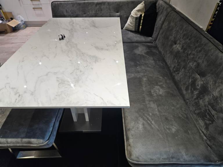 Table with corner chair, sofa and bench