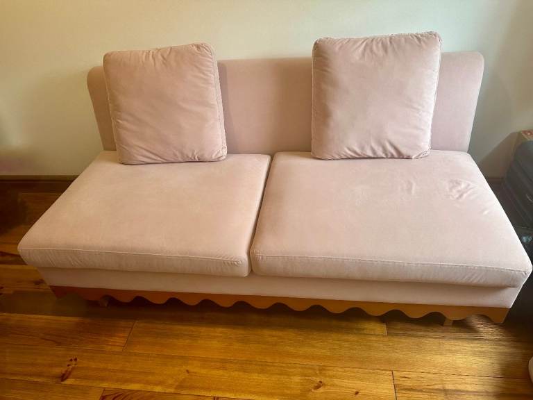 Solid wooden blush sofa with scalloped wavy feature