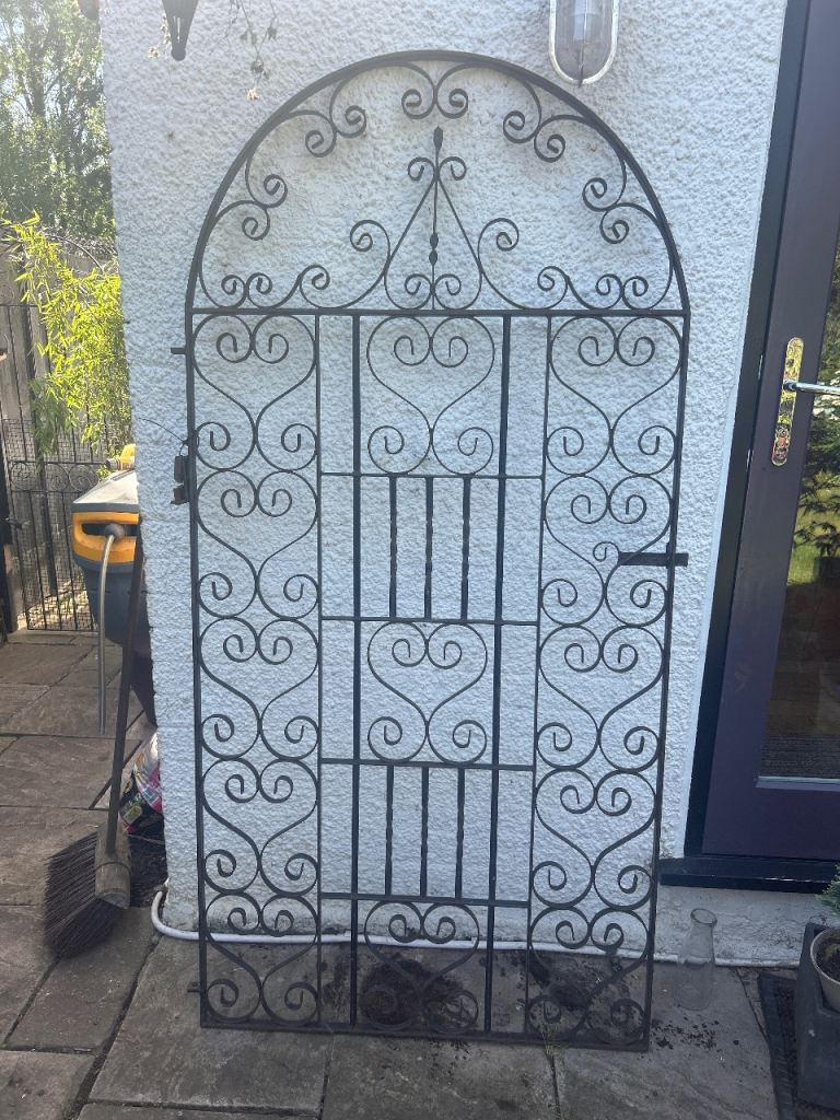 Large, heavy wrought iron arch top garden gate